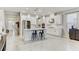 Spacious kitchen with a large island, modern pendant lighting, stainless steel appliances, and white cabinets at 33886 Landsman Loop, Wesley Chapel, FL 33543
