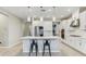 Bright, modern kitchen features an island with bar seating, stainless steel appliances, and pendant lighting at 33886 Landsman Loop, Wesley Chapel, FL 33543
