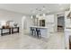 Open-concept kitchen with an island, stainless steel appliances, and a view to a table, and office beyond at 33886 Landsman Loop, Wesley Chapel, FL 33543