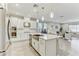 Open concept kitchen with an island, stainless steel appliances, and seamless flow into the living area at 33886 Landsman Loop, Wesley Chapel, FL 33543