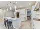 Contemporary kitchen with a large island, stainless steel appliances, white cabinetry and pendant lighting at 33886 Landsman Loop, Wesley Chapel, FL 33543