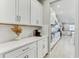 Kitchen featuring white cabinets, stainless steel appliances, and a view into the adjacent living space at 33886 Landsman Loop, Wesley Chapel, FL 33543