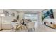 Well-lit living room with sliding doors, modern decor, and a view of the backyard at 33886 Landsman Loop, Wesley Chapel, FL 33543