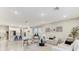Bright and airy living room and kitchen with recessed lighting and wood-look tile flooring throughout at 33886 Landsman Loop, Wesley Chapel, FL 33543