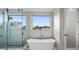Bright bathroom with soaking tub, walk-in shower, and neutral color palette at 5131 W Neptune Way, Tampa, FL 33609