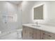 Modern bathroom features sleek vanity, illuminated mirror, and glass-enclosed shower at 5131 W Neptune Way, Tampa, FL 33609
