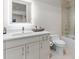 Modern bathroom features sleek vanity, illuminated mirror, and glass-enclosed shower at 5131 W Neptune Way, Tampa, FL 33609