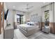 Bright main bedroom featuring a tufted headboard, neutral color palette and lots of windows at 5131 W Neptune Way, Tampa, FL 33609