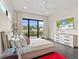 Bright bedroom features a large window, patio access, and a modern entertainment system at 5131 W Neptune Way, Tampa, FL 33609
