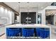 The modern kitchen has a large island, premium appliances, and sleek cabinetry at 5131 W Neptune Way, Tampa, FL 33609