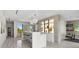 Open-concept living room with sleek bar area and modern light fixtures for a sophisticated feel at 5131 W Neptune Way, Tampa, FL 33609