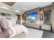 Modern main bedroom with built-in fireplace, TV, and elegant decor at 5131 W Neptune Way, Tampa, FL 33609