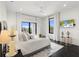 Bright main bedroom featuring large windows, access to a balcony, and dark wood flooring at 5131 W Neptune Way, Tampa, FL 33609