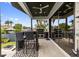 Back patio with outdoor kitchen, bar seating and lush garden views at 5131 W Neptune Way, Tampa, FL 33609