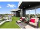 Inviting rooftop deck with artificial turf, comfortable seating, and city views at 5131 W Neptune Way, Tampa, FL 33609