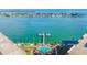 Stunning aerial view showcasing a waterfront property with a pier, swimming pool, and lush tropical landscaping at 5220 Brittany S Dr # 210, St Petersburg, FL 33715