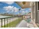 Balcony with seating overlooking the waterfront, bridge, and palm trees at 5220 Brittany S Dr # 210, St Petersburg, FL 33715