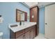 Bathroom featuring a wood vanity with a white countertop and blue walls at 5220 Brittany S Dr # 210, St Petersburg, FL 33715