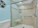 Modern bathroom featuring a tiled shower with a built-in seat and glass door at 5220 Brittany S Dr # 210, St Petersburg, FL 33715