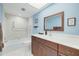 Bathroom features a shower-tub combination with white tiles and a wood vanity at 5220 Brittany S Dr # 210, St Petersburg, FL 33715