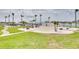 Outdoor community area featuring tables, palm trees, and water views for residents at 5220 Brittany S Dr # 210, St Petersburg, FL 33715