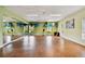 Bright exercise room featuring wood floors, ample natural light, and a mirrored wall perfect for fitness activities at 5220 Brittany S Dr # 210, St Petersburg, FL 33715