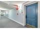 Well-lit condo hallway with neutral carpet, painted walls, unit door, and visible exit sign at 5220 Brittany S Dr # 210, St Petersburg, FL 33715