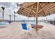 Resort-style pool area with lounge chairs, tiki umbrella, and views of the water at 5220 Brittany S Dr # 210, St Petersburg, FL 33715