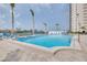 Inviting community pool features crystal clear water, sun loungers, and tropical palm trees at 5220 Brittany S Dr # 210, St Petersburg, FL 33715