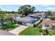 An elevated view of a cozy home featuring a screened pool and lush green lawn at 5248 Coral N Way, St Petersburg, FL 33714