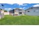 Expansive backyard with lush lawn and screened-in pool, ideal for outdoor activities and summer relaxation at 5248 Coral N Way, St Petersburg, FL 33714
