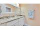 Elegant bathroom featuring double sinks, granite countertops, and ample lighting at 5248 Coral N Way, St Petersburg, FL 33714