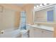 Inviting bathroom featuring a tub, a toilet, and a vanity with ample storage for toiletries and essentials at 5248 Coral N Way, St Petersburg, FL 33714