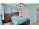 Bedroom with wood-look flooring, ceiling fan, and a large closet for storage at 5248 Coral N Way, St Petersburg, FL 33714