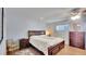 Comfortable bedroom with warm lighting, wood-look floors, and ample storage space at 5248 Coral N Way, St Petersburg, FL 33714