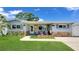 Charming single-story home featuring a beautifully landscaped front yard and stone facade at 5248 Coral N Way, St Petersburg, FL 33714