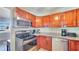 Functional kitchen with stainless steel appliances, granite countertops, and cherry wood cabinets at 5248 Coral N Way, St Petersburg, FL 33714