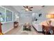 Bright living room with neutral colors, wood-look flooring, and a modern ceiling fan at 5248 Coral N Way, St Petersburg, FL 33714