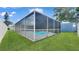 Exterior view of screened pool enclosure showcasing backyard at 5248 Coral N Way, St Petersburg, FL 33714