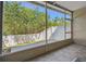 Serene screened patio with a clear view of the lush, green backyard and white fence, perfect for outdoor enjoyment at 542 Black Lion Ne Dr, St Petersburg, FL 33716