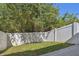 Private backyard with a white fence and lush greenery at 542 Black Lion Ne Dr, St Petersburg, FL 33716