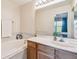 Bright bathroom features a soaking tub, white counters, and natural wood cabinets at 542 Black Lion Ne Dr, St Petersburg, FL 33716