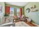 This green room has two windows, wood floors, and an assortment of decor at 542 Black Lion Ne Dr, St Petersburg, FL 33716