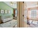 Cozy Bedroom with crib, animal artwork, and warm curtains, transitioning to a bedroom with pink curtains and natural light at 542 Black Lion Ne Dr, St Petersburg, FL 33716
