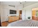 This bedroom has high ceilings, wood floors, and a view into the Primary bathroom at 542 Black Lion Ne Dr, St Petersburg, FL 33716