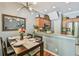 Dining area with table set for four, modern lighting, and view into the kitchen at 542 Black Lion Ne Dr, St Petersburg, FL 33716