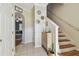 Welcoming foyer with tile flooring, staircase, and decor leading to a living area at 542 Black Lion Ne Dr, St Petersburg, FL 33716