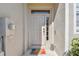 Inviting front entry featuring a modern door with sidelight and a colorful 'HELLO' welcome mat at 542 Black Lion Ne Dr, St Petersburg, FL 33716