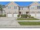 Well-maintained townhouse with attached garage and landscaped front yard on a bright, sunny day at 542 Black Lion Ne Dr, St Petersburg, FL 33716
