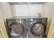 The laundry room features front loading, gray washer and dryer units at 542 Black Lion Ne Dr, St Petersburg, FL 33716